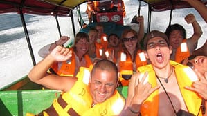 Travelers enjoy the sea spray on a speed boat ride from Panama to Colombia on board the Darien Gapster