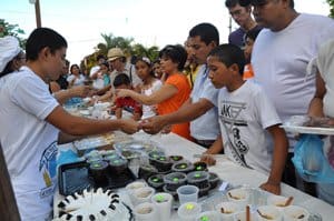 Veraguas festival goers look over a table of cheap and sweet treats in Panama