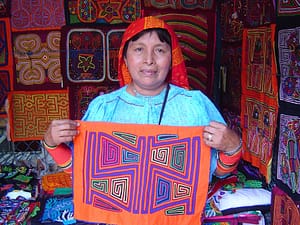 A Guna woman displays mola art she has crafted.